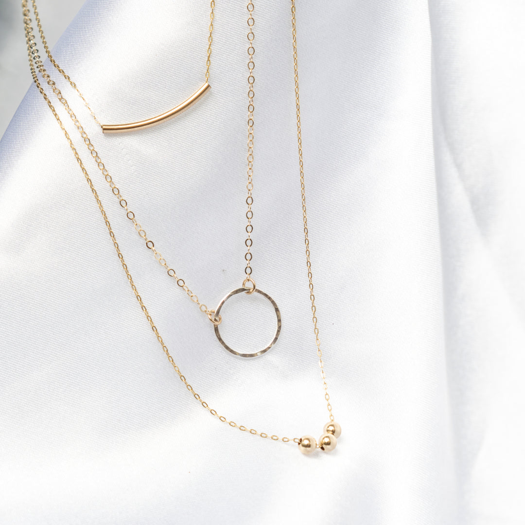 Curated everyday stacked set with curved bar necklace hammered circle necklace and bead necklace in sterling silver or 14k gold filled