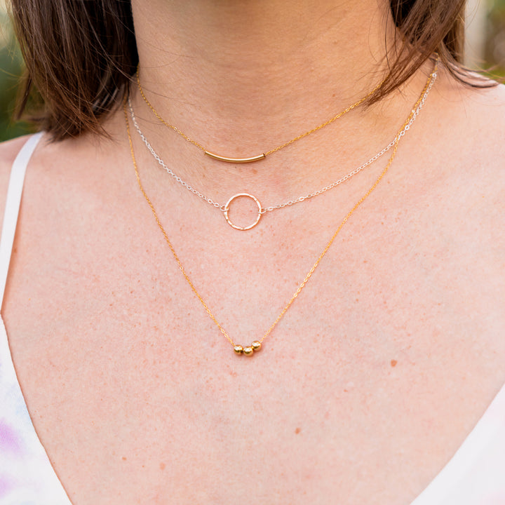 Curated everyday stacked set with curved bar necklace hammered circle necklace and bead necklace in sterling silver or 14k gold filled