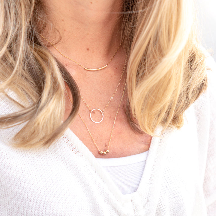 Curated everyday stacked set with curved bar necklace hammered circle necklace and bead necklace in sterling silver or 14k gold filled