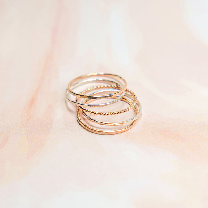 mixed metal hammered and twisted stacking rings in sterling silver and 14k gold filled