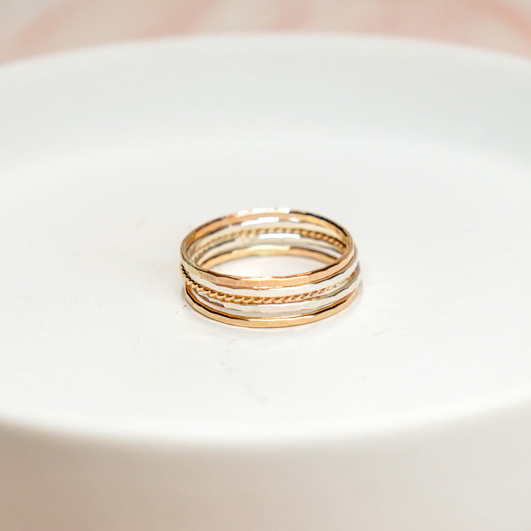 mixed metal hammered and twisted stacking rings in sterling silver and 14k gold filled