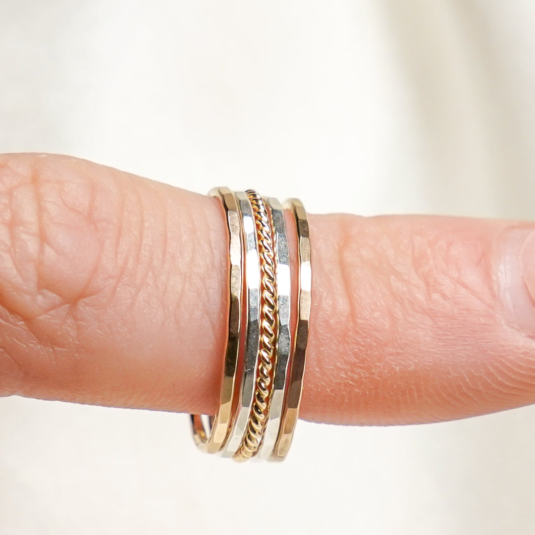 mixed metal hammered and twisted stacking rings in sterling silver and 14k gold filled