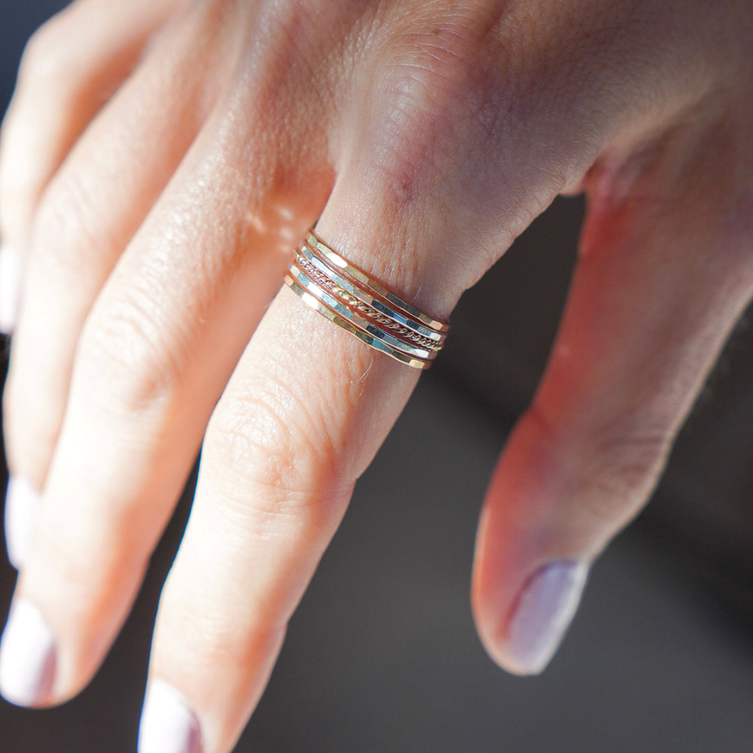 mixed metal hammered and twisted stacking rings in sterling silver and 14k gold filled