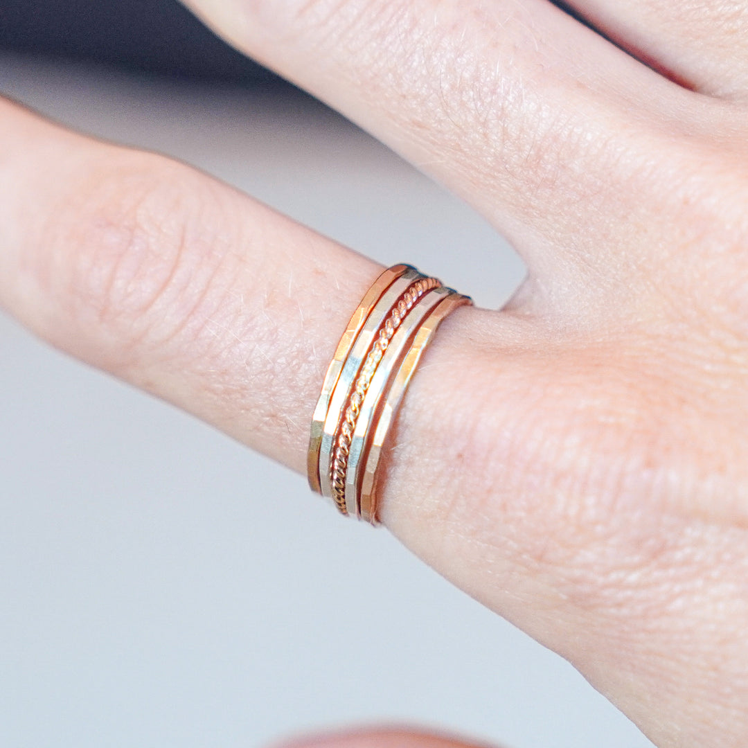 mixed metal hammered and twisted stacking rings in sterling silver and 14k gold filled